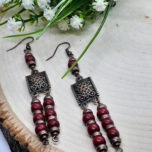 Antique copper filigree earring accented with red wooden beads and copper spacer